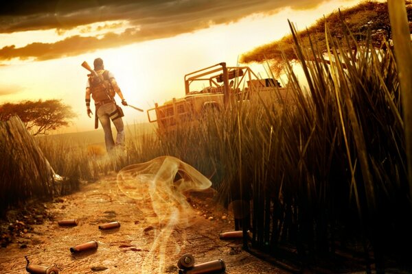 Герой гри Farcry 4 в повному бойовому озброєнні йде по дорозі до свого джипу на тлі західного неба